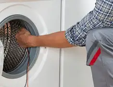 Dryer repair technician diagnosing and servicing a clothes dryer in Ogden, UT