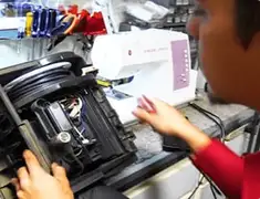 Vacuum repair technician servicing internal components on a workbench in Ogden, UT