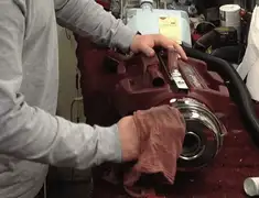 Vacuum repair technician cleaning and servicing a vacuum motor in Ogden, UT